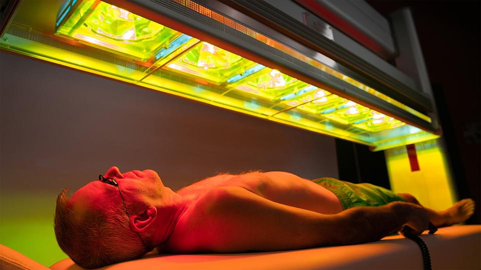 Photo of man receiving full body treatment with RX6 PBM model